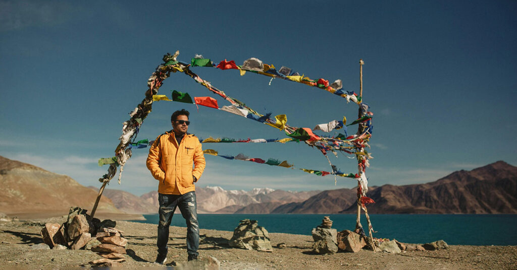 man wearing warm jacket at Pangong Tso