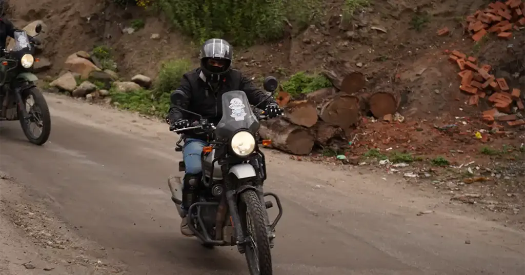 A solo rider riding through patchy road of Spiti Vlley
