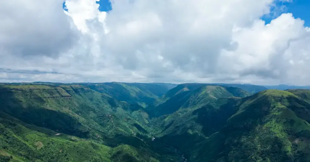 Cloudy view of the green valleys and hills of Laitlum Canyon in Meghalaya