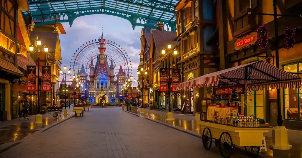 VinWonders Phu Quoc theme park street leading to a lit-up castle and ferris wheel