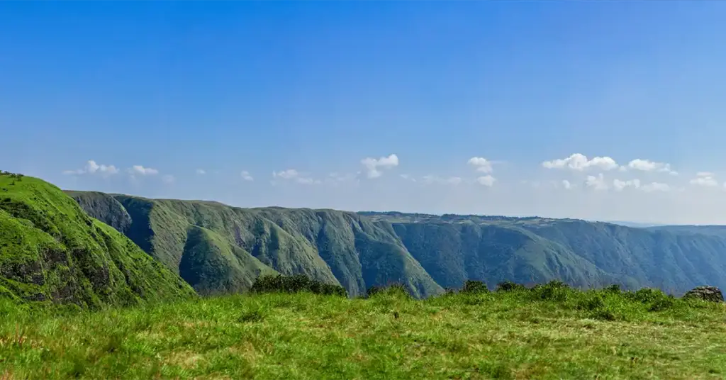 Panoramic view of the rolling green cliffs and valleys of Laitlum Canyon near Shillong, Meghalaya