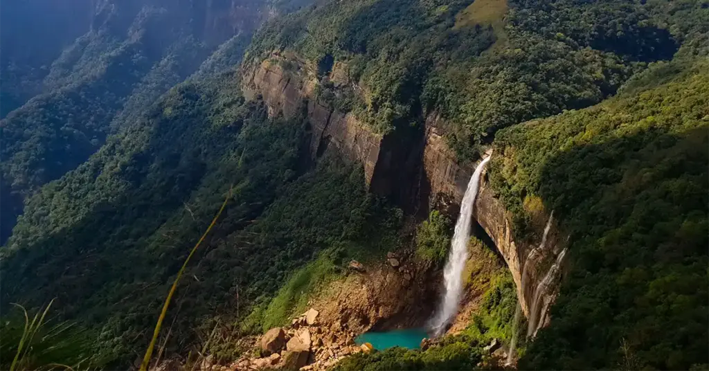 Nohkalikai Falls plunging into a turquoise pool surrounded by cliffs near Cherrapunji, Meghalaya