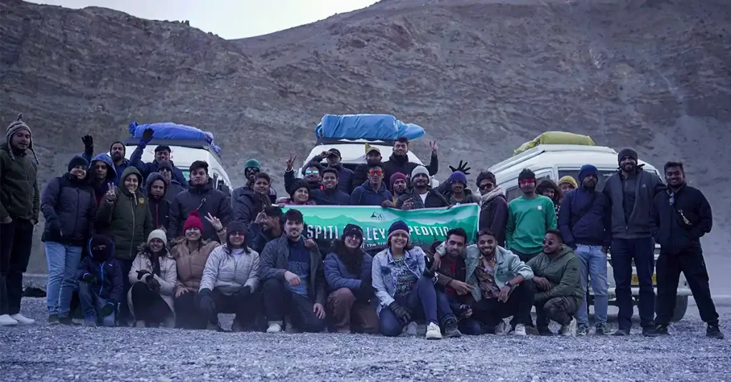 The Travel Story group on a Spiti Valley Expedition batch with tempo travellers and luggage loaded on the roof