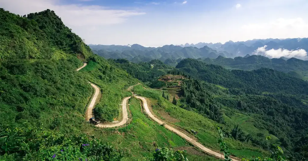 Winding switchback road through the green karst mountains of Ha Giang, northern Vietnam